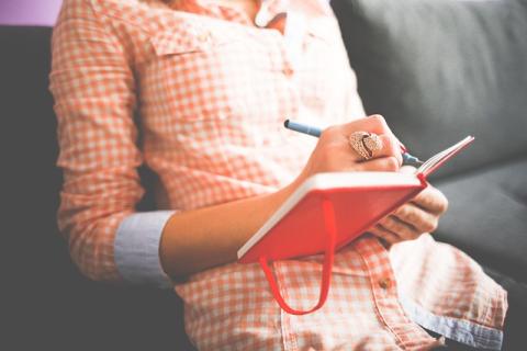 Woman writing in notebook