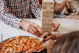 Pizza and people playing Jenga