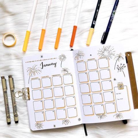 bullet journal that reads january. pens layed out.