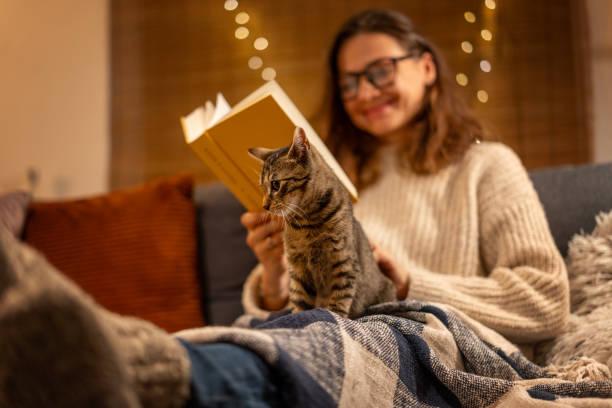 teen reading with kitten