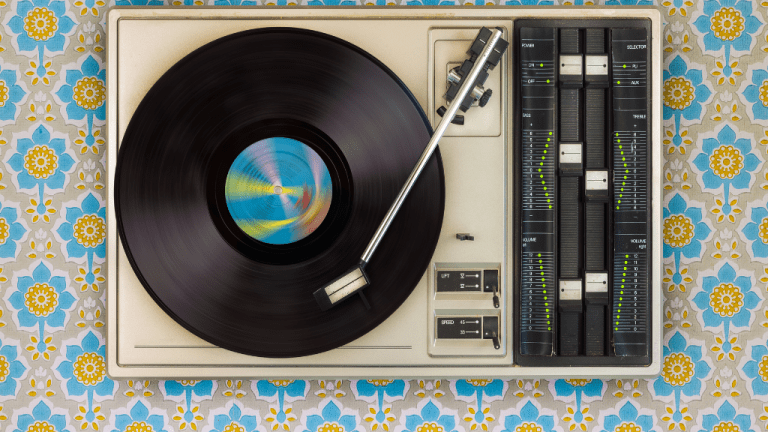 A photograph of a black vinyl record spinning on a turntable. 